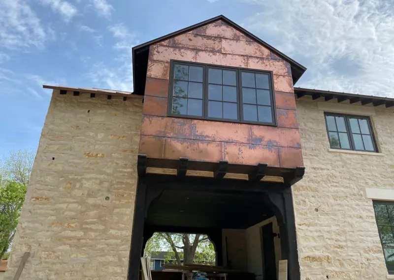 Copper metal panel facade on a stone building for Metal Roof Coating in Richardson