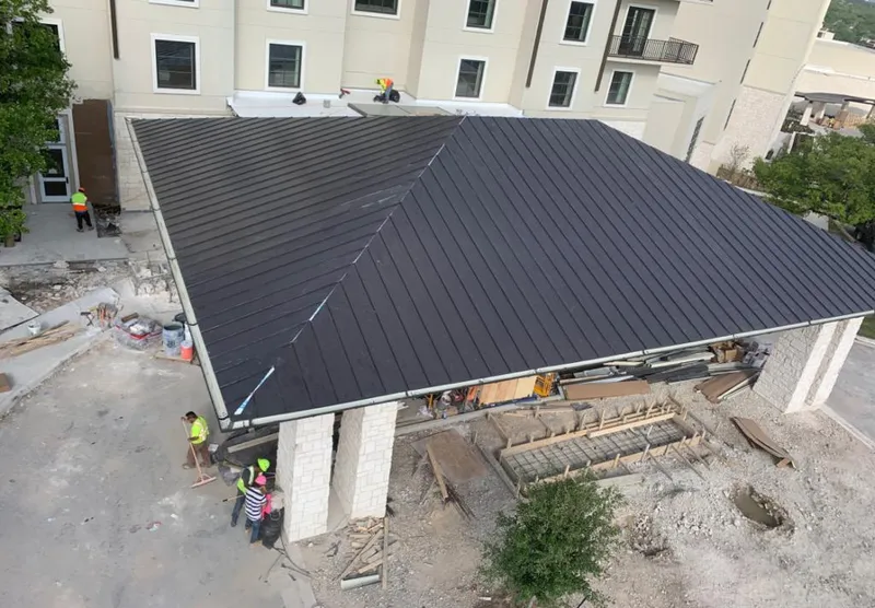 Metal roofing installation team working on a commercial building in Richardson