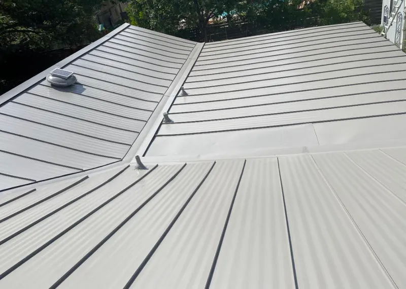 Solar attic fan installed on a metal roof for Roof Ventilation in Richardson